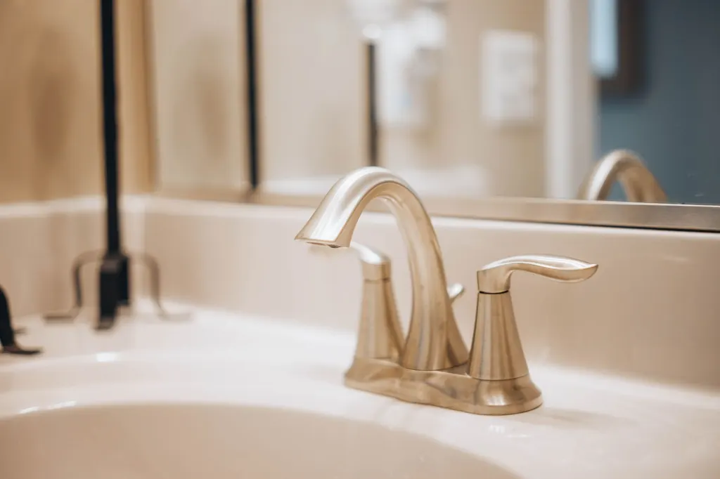 Hard water scale deposits on a bathroom faucet — signs of hard water in Acton
