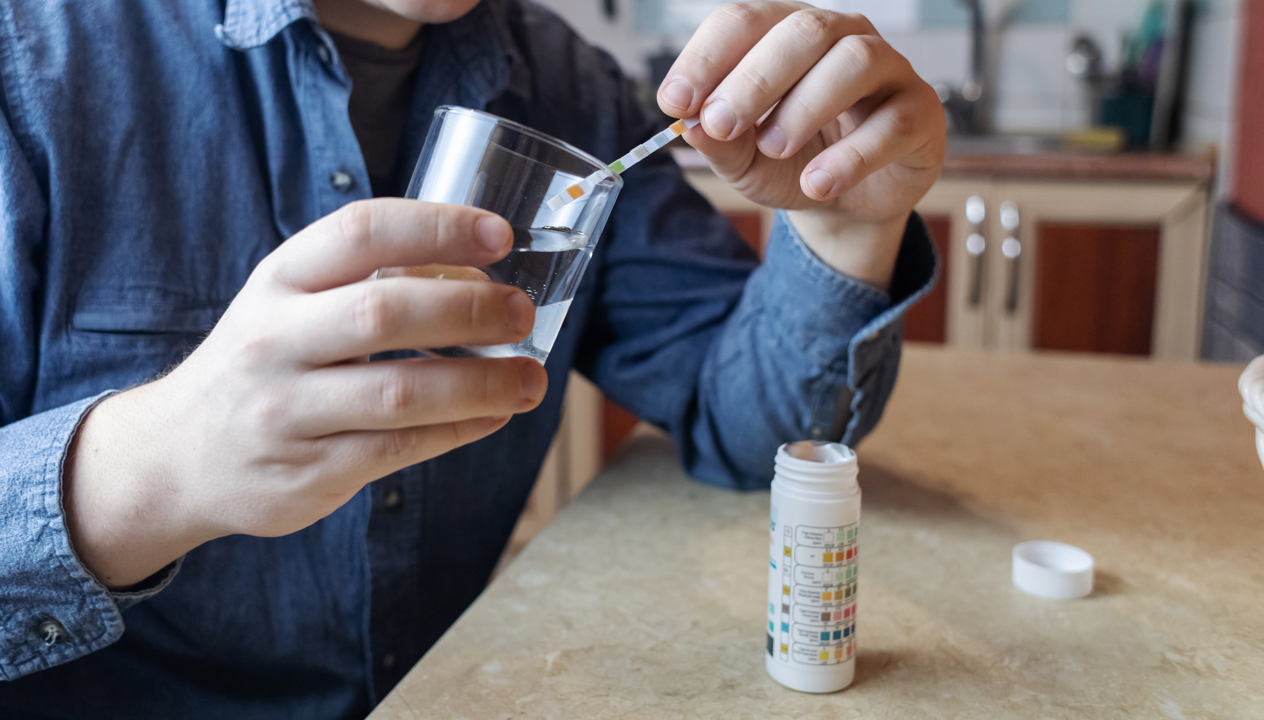 Water hardness test strip showing hard water reading